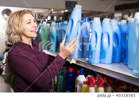 Woman choosing detergent in shop Woman choosing detergent in shop 40338565