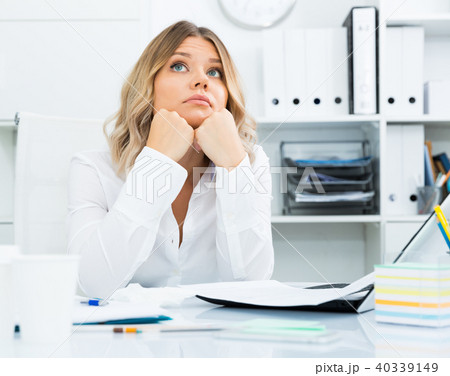 Pensive young girl in business clothes in modern office Pensive young girl in business clothes in modern office 40339149