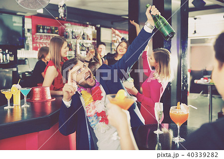 Cheerful guy expressively dancing partying in bar Cheerful guy expressively dancing partying in bar 40339282