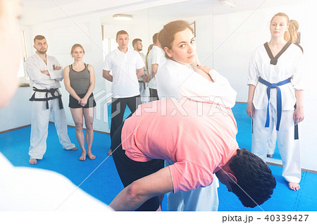 Smiling woman is showing new submission hold to adults Smiling woman is showing new submission hold to adults 40339427