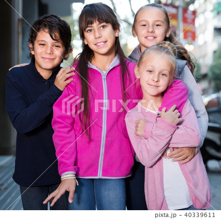 four happy children play without parents on sidewalk in modern city 40339611