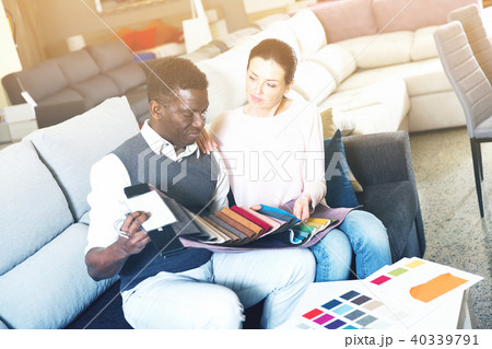 Joyful couple is choosing colors for furniture Joyful couple is choosing colors for furniture 40339791