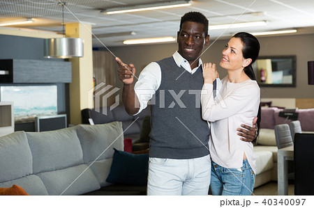 Adult woman with her husband are looking on modern furniture for their house Adult woman with her husband are looking on modern furniture for their house 40340097