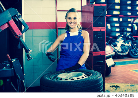 Mechanic working on car wheel Mechanic working on car wheel 40340389