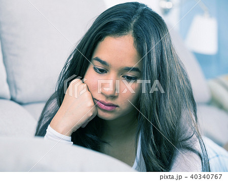 young female sad and thinking on sofa 40340767