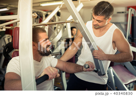 Guy with trainer in gym Guy with trainer in gym 40340830