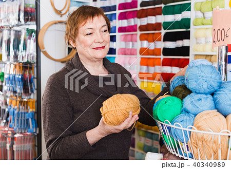 Mature woman buying yarn for their hobby on special offers 40340989
