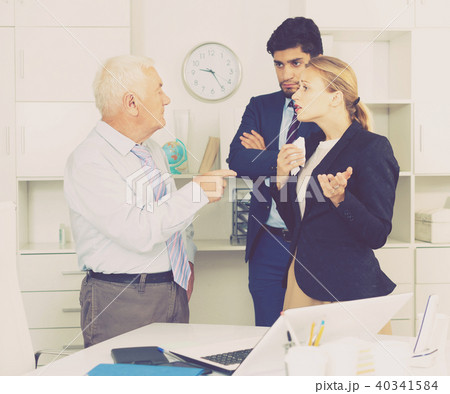 Mature businessman is chastising employees because of uncompleted work 40341584