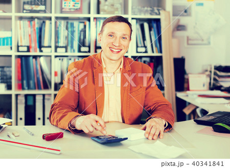 Smiling manager working at office desk 40341841
