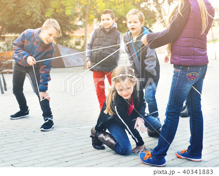 Children games. Girl goes through the tangled rope Children games. Girl goes through the tangled rope 40341883