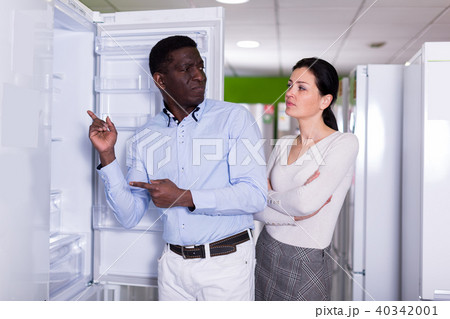female and male chooses refrigerator 40342001
