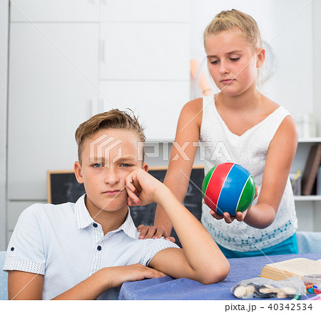 Sister is asking forgiveness from her offendedly brother and offering to play ball 40342534