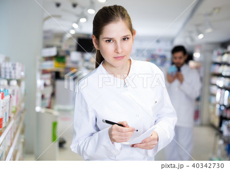 pharmacist carefully keeps a re-inventory of medicines pharmacist carefully keeps a re-inventory of medicines 40342730
