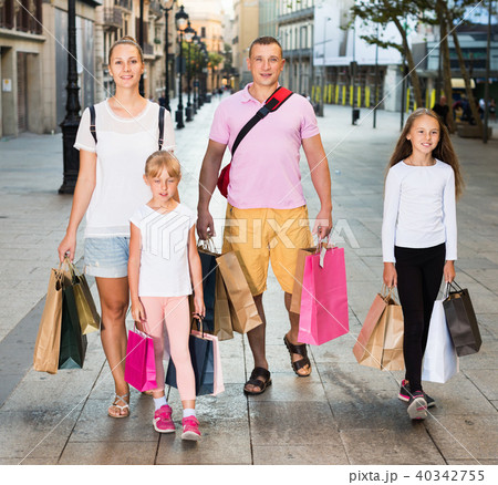 Portrait of family of four people happily shopping together in the city Portrait of family of four people happily shopping together in the city 40342755