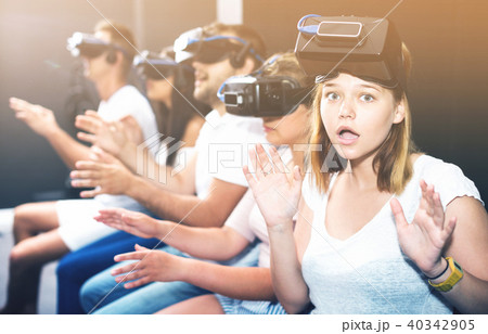 Portrait of frightened young girl after watching of exciting movie with VR glasses 40342905