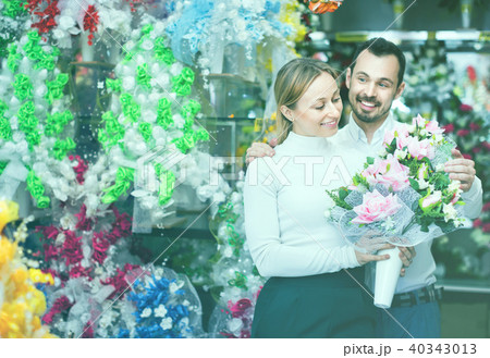 Couple choosing trendy flower decoration in store 40343013