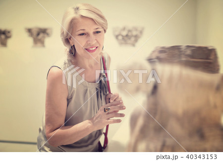 Adult female looking at artwork sculpture in the museum indoors 40343153
