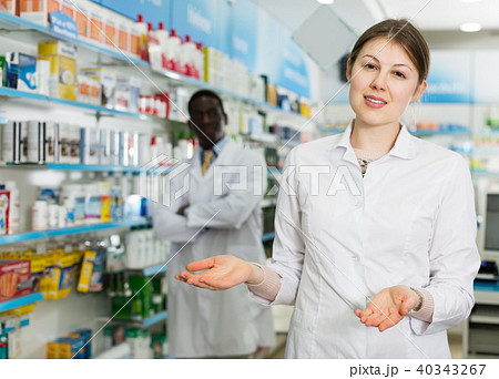 female pharmacist inviting to drugstore 40343267