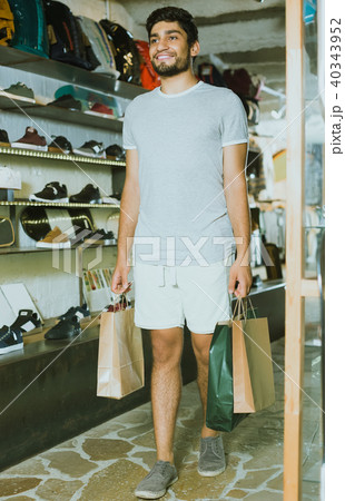 man with paper bags in the modern shop man with paper bags in the modern shop 40343952