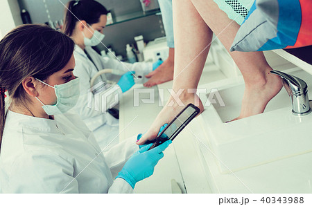 Nail pedicure technician performing procedure 40343988