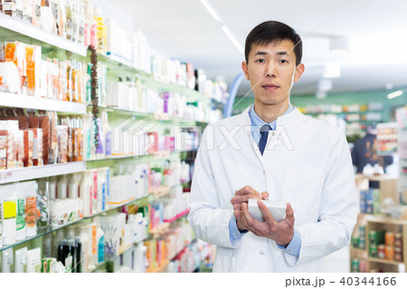 male pharmacist is inventorying medicines male pharmacist is inventorying medicines 40344166