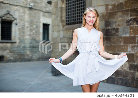 cheerful woman holding skirt in the hand cheerful woman holding skirt in the hand 40344301