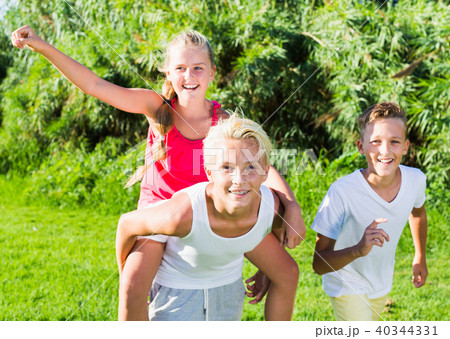 Happy children running together outdoors 40344331