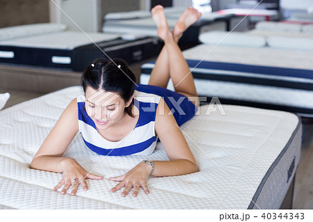 Female is lying on bed and posing playfully Female is lying on bed and posing playfully 40344343