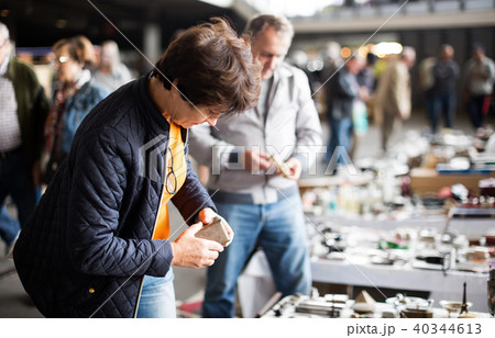 Woman buying retro handicrafts on indoor flea market 40344613