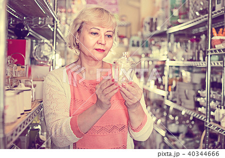 customer female choosing glass sugar bowl in the dishes shop 40344666
