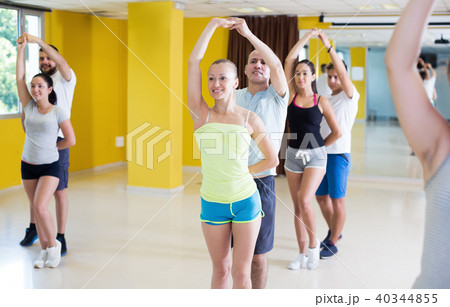 Positive couples of adults practicing salsa in studio Positive couples of adults practicing salsa in studio 40344855