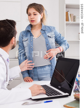 Doctor and girl with pain in side Doctor and girl with pain in side 40344895