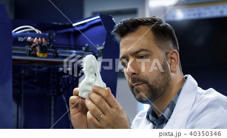 Man exploring dinosaur miniature 3-D skull 40350346