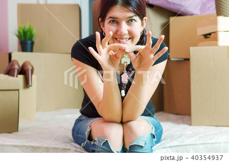 Photo of young brunette with keys from apartment in apartment 40354937