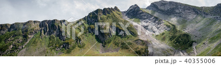 Photo of mountain slopes with vegetation and cloudy sky Photo of mountain slopes with vegetation and cloudy sky 40355006