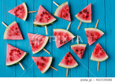 Watermelon slice popslices on a blue wooden background. Freshnes Watermelon slice popslices on a blue wooden background. Freshnes 40359086