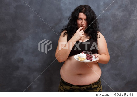 Dieting concept. Young obese overweight woman fighting the tempt 40359943