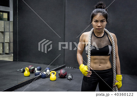 Young gymnast woman posing  with gymnastics rope 40360122