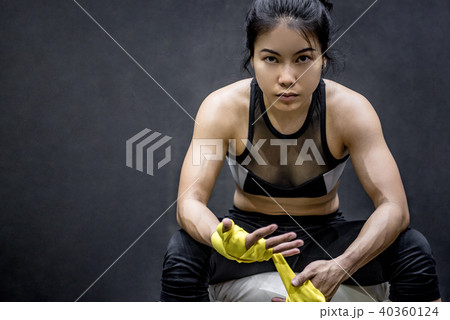 boxer woman wearing yellow strap on wrist 40360124