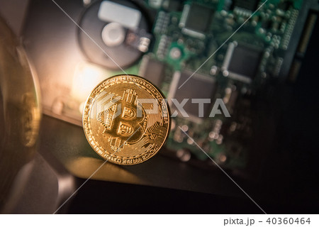 Bitcoin gold coin with blurry hard disk drive 40360464