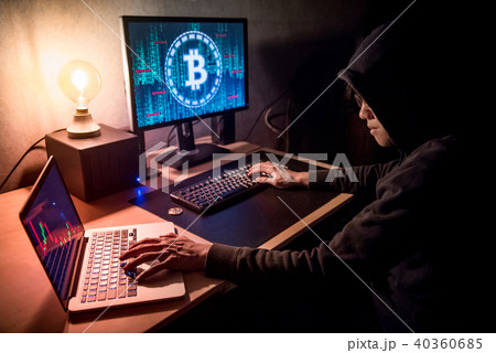 Hacker man using computer for digital currency laundering 40360685