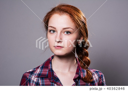 Portrait of a young red-haired girl in a plaid  40362846