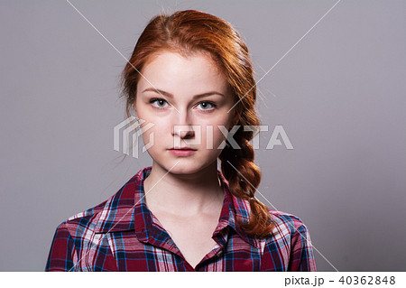 Portrait of a young red-haired girl in a plaid  40362848