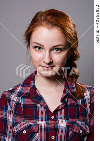 Portrait of a young red-haired girl in a plaid  40362852
