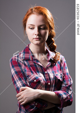 Young red-haired girl with a pigtail in a plaid  40362859