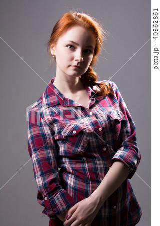 Young red-haired girl with a pigtail in a plaid  40362861