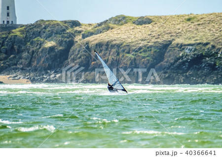 Wind surfer enjoys the beach at Newborough Warren with the Island of Llanddwyn in the background 40366641