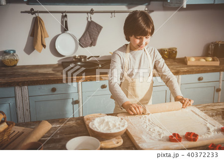 Little boy making tasty cookies himself 40372233