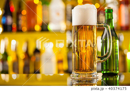 Jug of beer with bottle served on bar counter Jug of beer with bottle served on bar counter 40374175