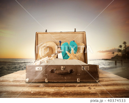 Travel concept with old suitcase on wooden planks Travel concept with old suitcase on wooden planks 40374533